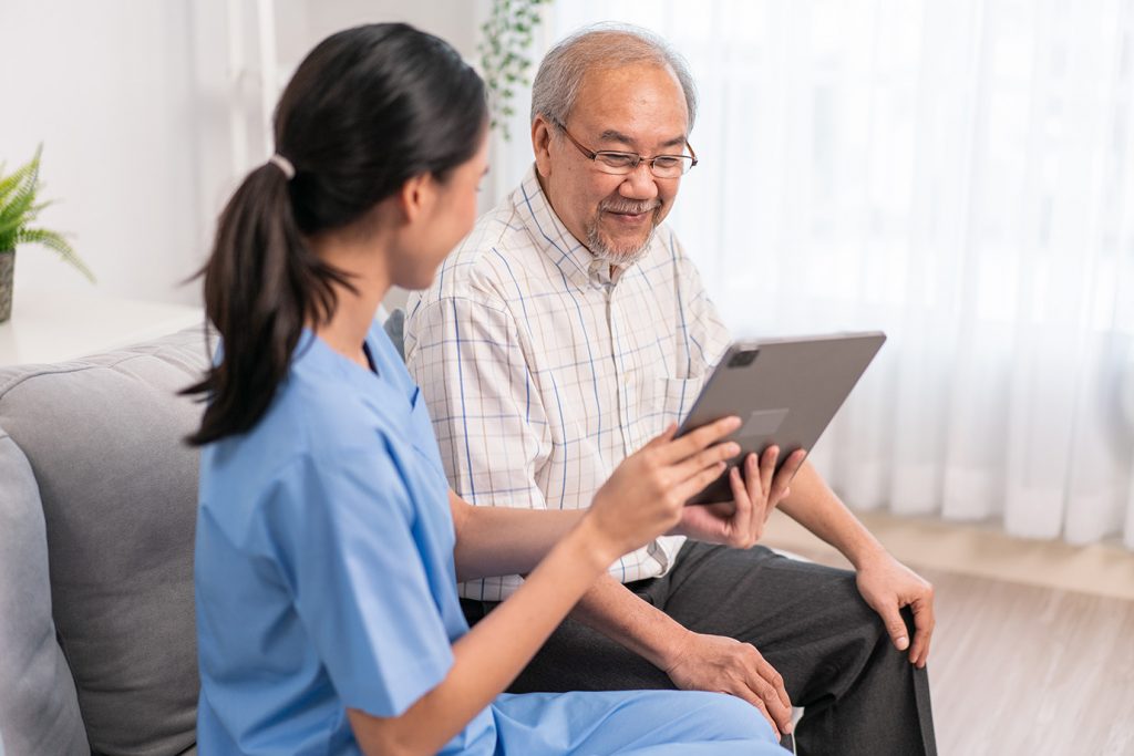 Asian nurse showing health checkup report to grandfather